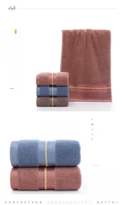 Detail view of cotton towels set with delicate loop texture and gold woven stripes