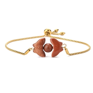 Detail of golden box chain bracelet featuring natural stone butterfly wing elements