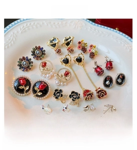 Collection of floral tulip and pearl earrings in assorted enamel and gold finishes