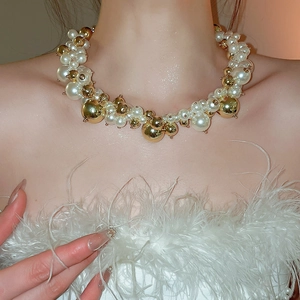 Close-up of elegant French irregular beaded pearl necklace with golden accent beads
