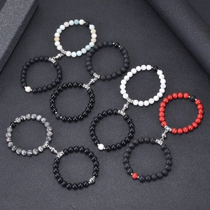 Lava stone and turquoise couple bracelets with magnetic attraction clasp on dark background