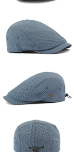 Detail of light blue breathable plaid flat cap with metal logo and adjustable drawstring