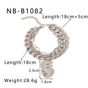Detailed view of layered silver Cuban chain bracelet with abstract face pendant and size specs