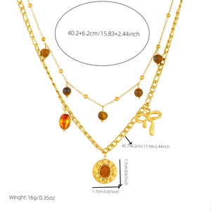 Double-layered gold necklace with sun pendant, tiger eye stone, and bow accessory