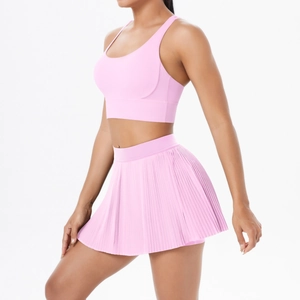 Detailed view of pink breathable yoga set with sports bra and pleated tennis skirt