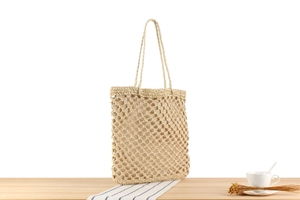 Detail shot of beige woven tote bag with sturdy fabric lining and mesh hollow texture