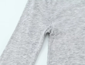 Macro shot of flat seam stitching on heather grey knit fabric showing detail and texture