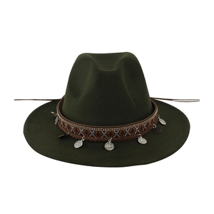 Detail of dark green fedora featuring ethnic woven band and hanging silver coins
