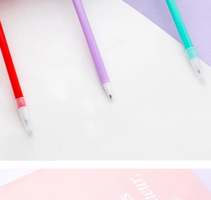 Close-up of colorful matte plastic ballpoint pens in red, purple and teal colors