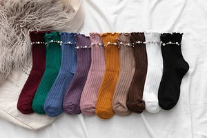 Detailed view of ten colors of ribbed cotton socks with elegant pearl and bead trim