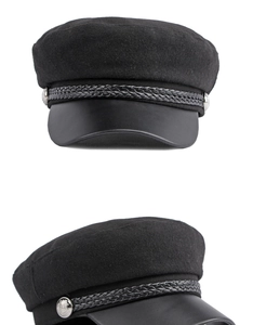 Detail of wool naval cap with leather brim, braided rope and silver crest buttons