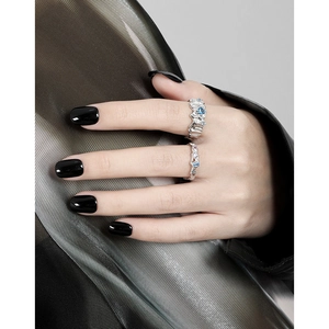 Irregular silver rings with blue zircon and white diamonds on model hand