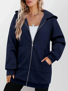 Detail of navy blue zip-up hoodie featuring a drawstring hood and ribbed cuffs