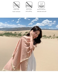 Detail of pink houndstooth cashmere shawl showing thick knit texture against a desert scenery
