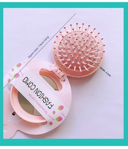 Pink strawberry folding travel hairbrush with massage cushion and round mirror details