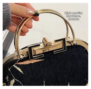 Close-up of premium gold hardware and floral embroidery on a black Chinese style handbag
