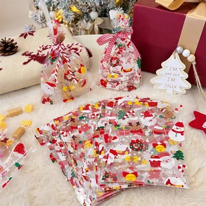 Detailed view of festive transparent Christmas candy bags with Santa and reindeer patterns