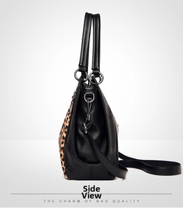 Side view of leopard print and black pebbled leather tote bag with metallic zipper details
