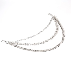 Close-up of triple-layered silver punk waist chains with textured curb links and clasps