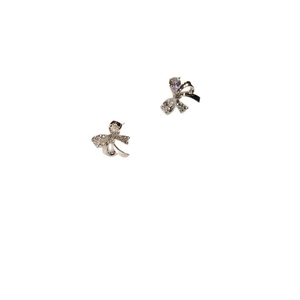 Silver bow stud earrings with zircon stones and ribbon design on white background