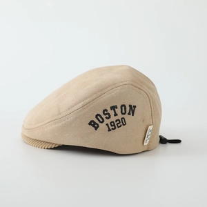 Macro detail of beige faux suede beret featuring side Boston 1920 print and back drawstring