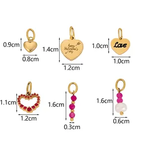 Detail view of heart-shaped pendants with happy Valentine's day engraving and pink gems