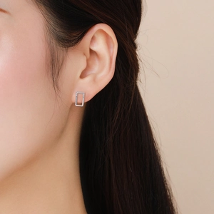 Minimalist 925 sterling silver rectangular micro-set stud earring worn by a model