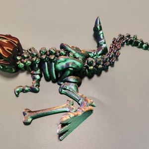 Detailed 3D printed dragon skeleton with movable joints in green and bronze gradient
