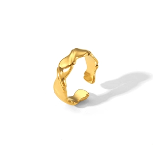Detailed view of the irregular gold wavy hammered texture on a stainless steel ring