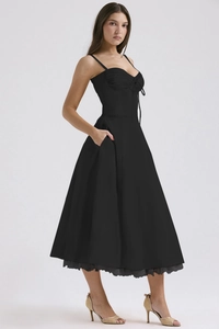 Detail of a black floral midi dress featuring lace hem and side pockets for women