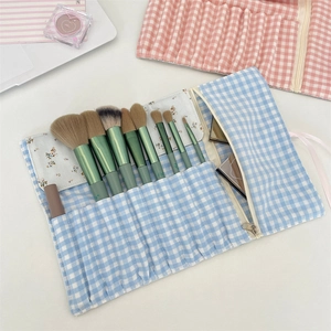 Floral makeup brush roll bag with blue and pink plaid patterns and inner zipper pocket
