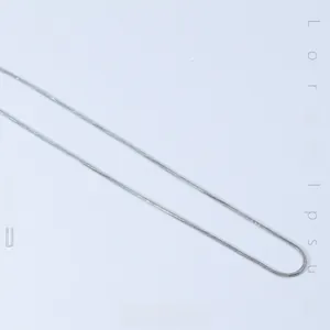 Detailed view of silver snake bone chain showing its smooth metallic texture and cold luster
