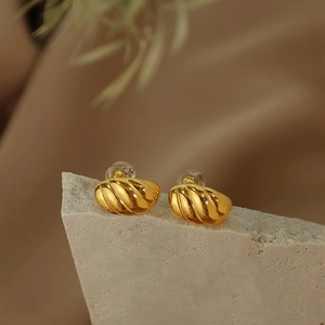 Elegant gold-plated C-shaped croissant hoop earrings with a textured spiral twist pattern