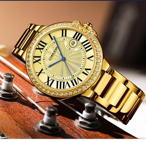 Detailed close-up of a gold men's watch featuring a diamond bezel and blue steel hands
