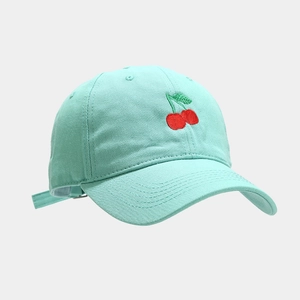Detailed view of mint green cotton baseball cap with red cherry embroidery and air vents