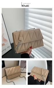 Detail view of khaki quilted crossbody bag with silver chain strap and stitching