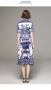 Back view of a blue and white Mediterranean floral print midi dress with waist belt