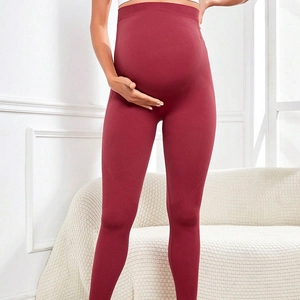 High-waisted seamless burgundy maternity leggings with belly support for pregnancy
