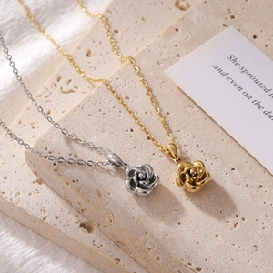 Elegant rose flower pendant necklace in gold and silver finishes on stone blocks