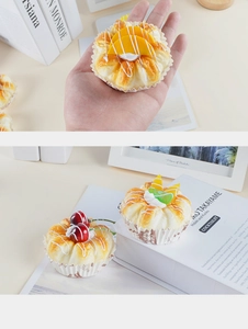 Macro detail of artificial fruit bread models with realistic cream and paper liners