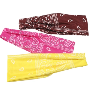 Three elastic paisley sport headbands in burgundy, bright pink, and yellow colors