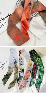 Detailed macro view of four 100% silk skinny scarves featuring oil painting art patterns