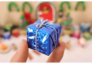 Close-up of a miniature blue gift box with silver ribbon for Christmas scene decoration