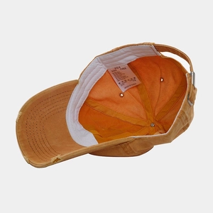 Distressed mustard cotton baseball cap with interior sweatband and adjustable buckle