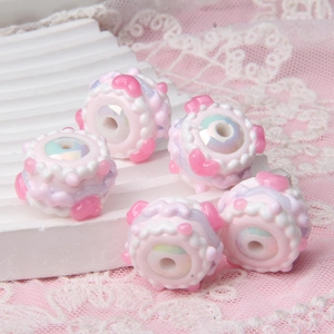 Macro view of handmade pink cake acrylic beads for DIY phone chains and jewelry making