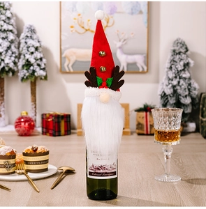 Close-up of a festive Christmas gnome wine bottle cover with reindeer antlers and tiny bells