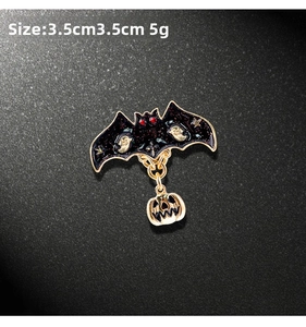 Detail of Halloween bat brooch with ghost patterns and hanging gold pumpkin charm, 3.5cm size