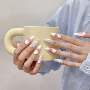 Handmade almond press-on nails with white base, pink blush ombré, and silver star glitter