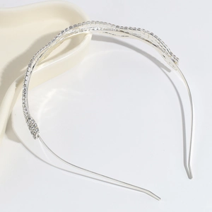 Detailed view of shimmering silver rhinestone wavy headband with elegant crystal inlay