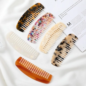 Detailed set of six wide-tooth acetate combs with diverse marble and floral patterns